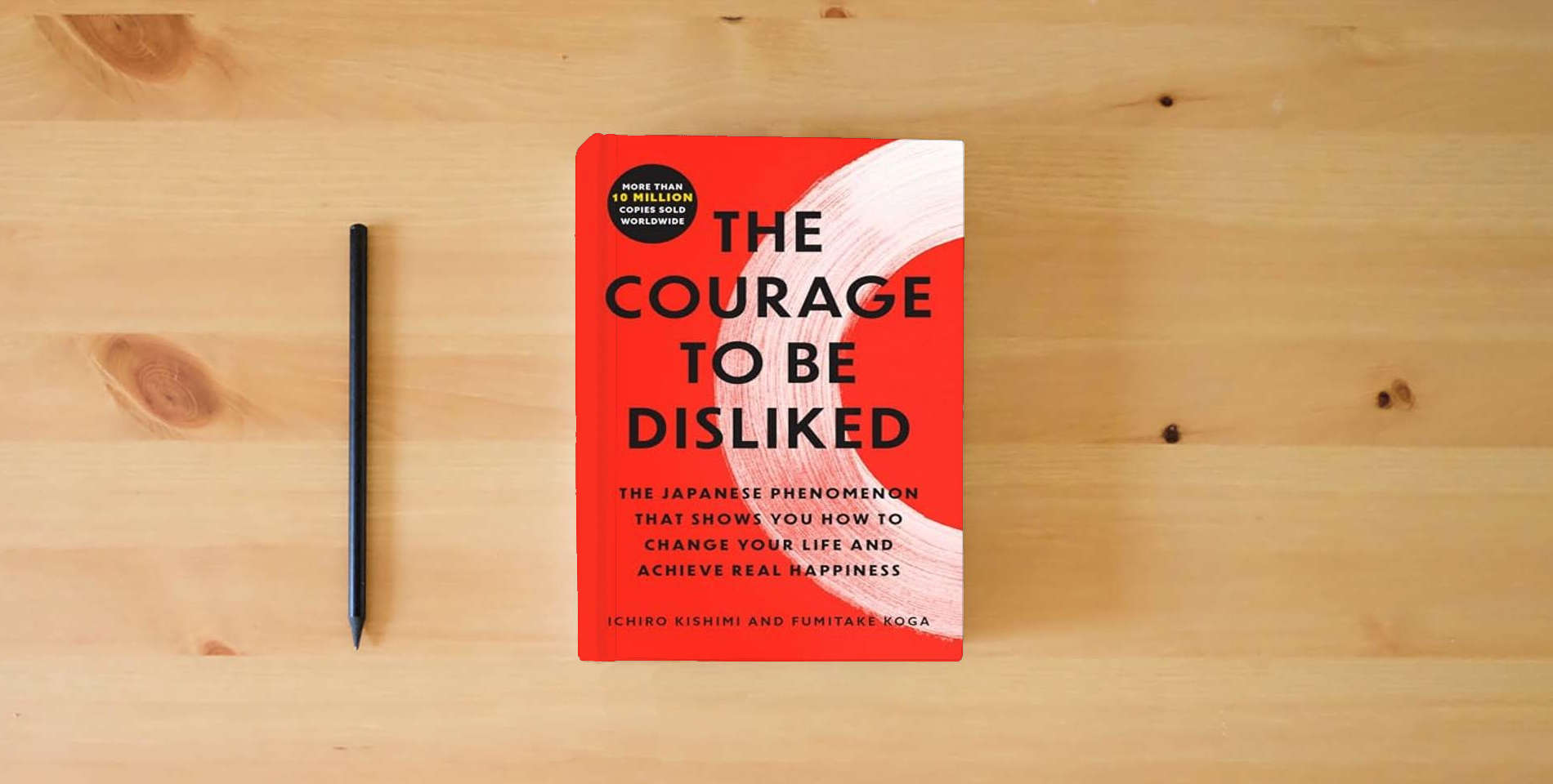 The book The Courage to Be Disliked: The Japanese Phenomenon That Shows You How to Change Your Life and Achieve Real Happiness is on the table