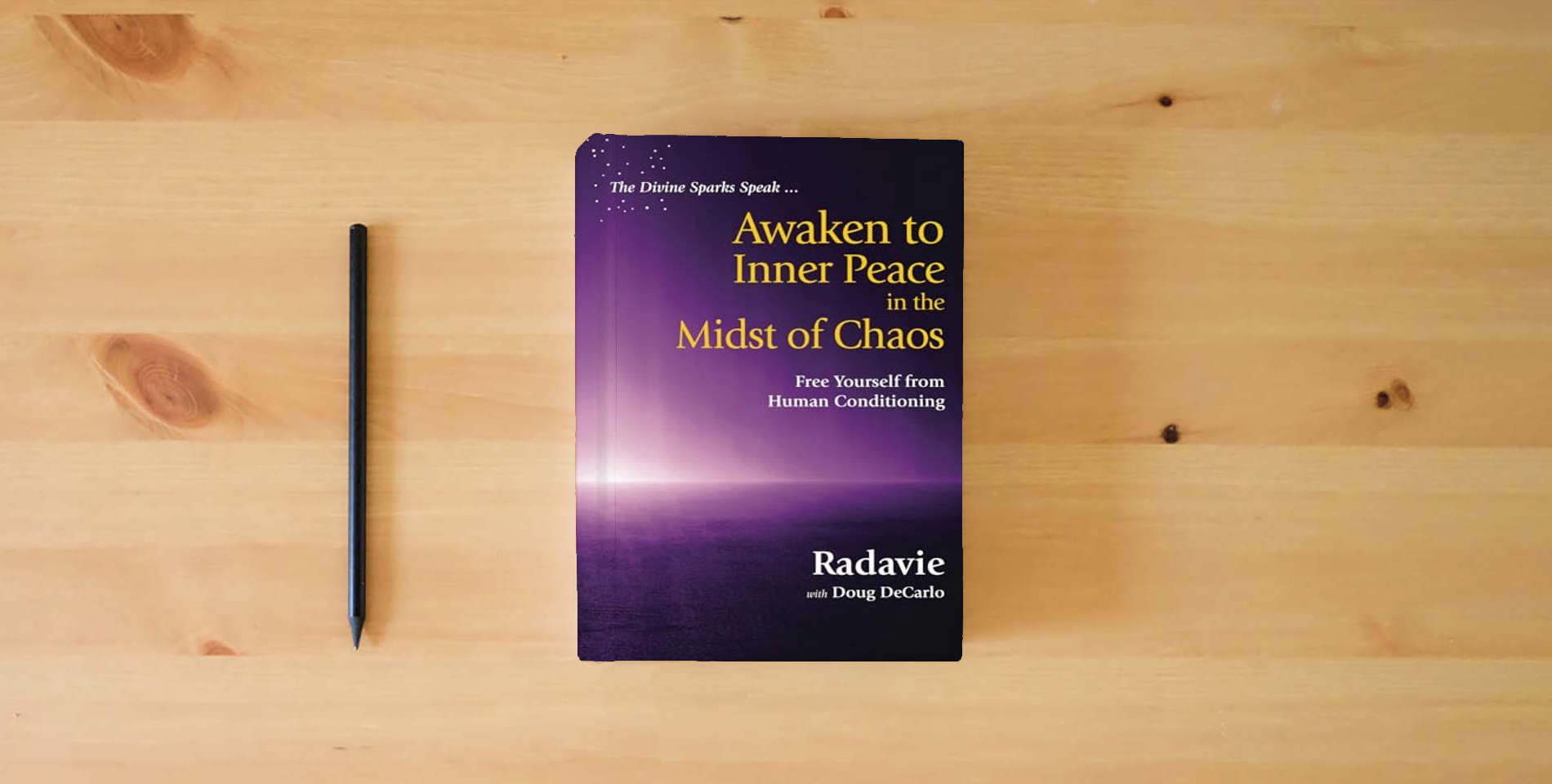 The book The Divine Sparks Speak ... Awaken to Inner Peace in the Midst of Chaos: Free Yourself from Human Conditioning is on the table