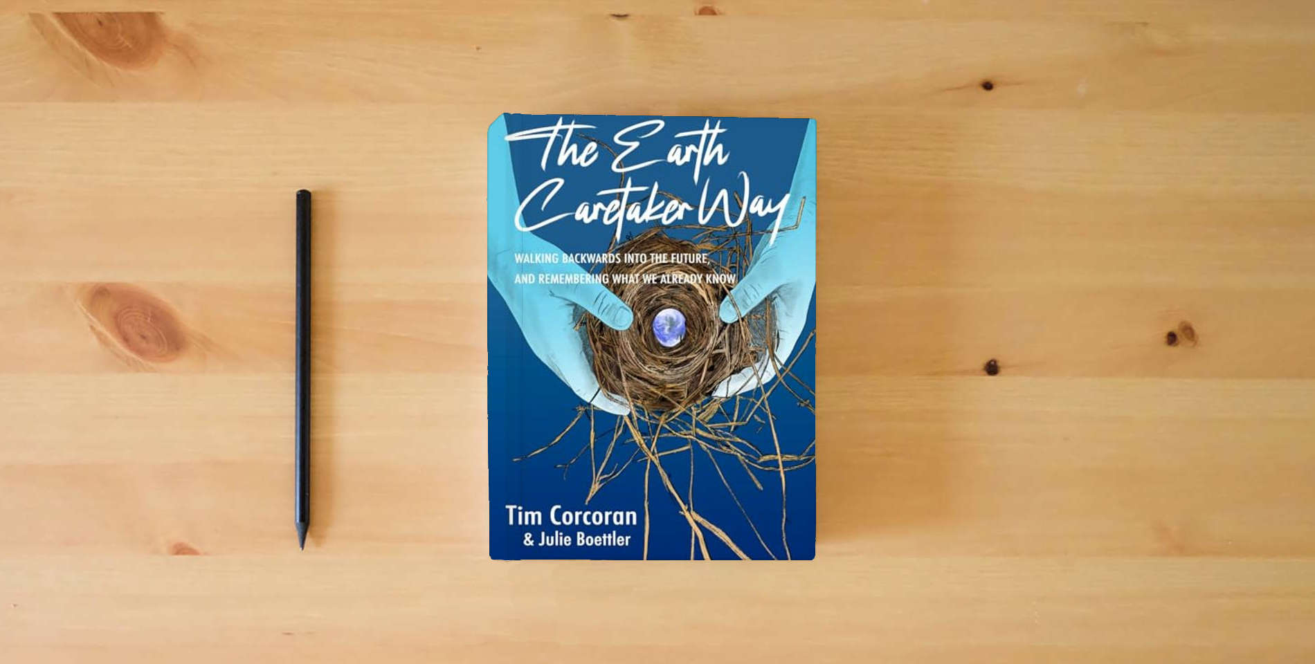 The book The Earth Caretaker Way is on the table