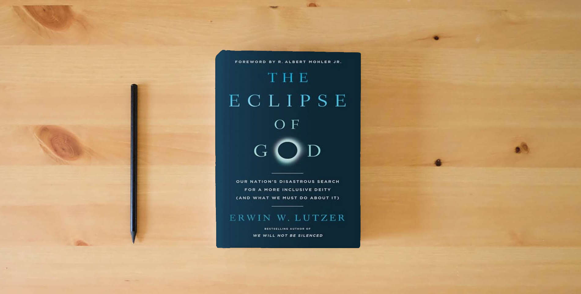 The book The Eclipse of God: Our Nation's Disastrous Search for a More Inclusive Deity (and What We Must Do About It) is on the table