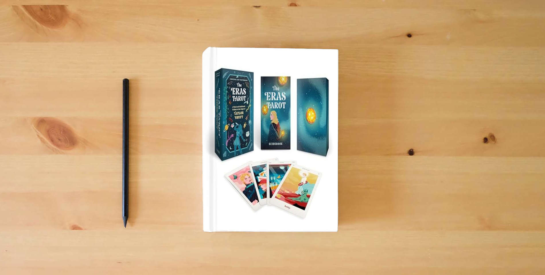 The book The Eras Tarot: A Deck and Guidebook Tribute to the Magic of Taylor Swift (Unofficial and Unauthorized) is on the table