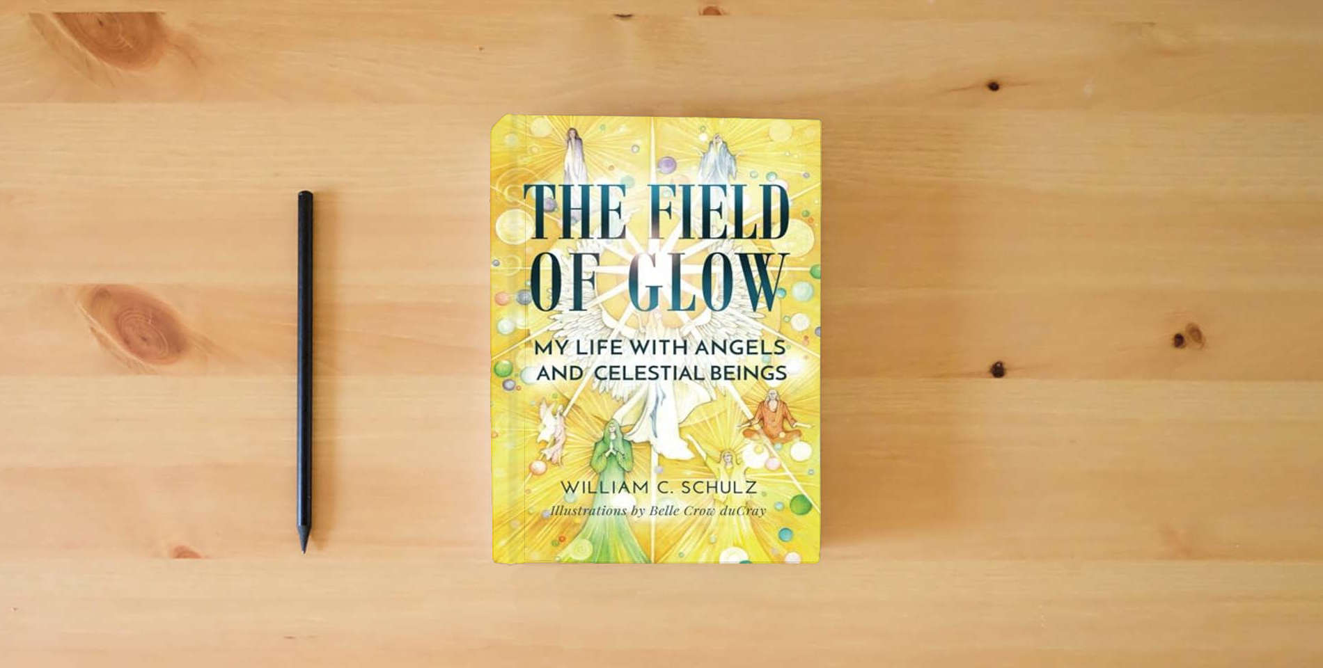 The book The Field of Glow: My Life with Angels and Celestial Beings is on the table