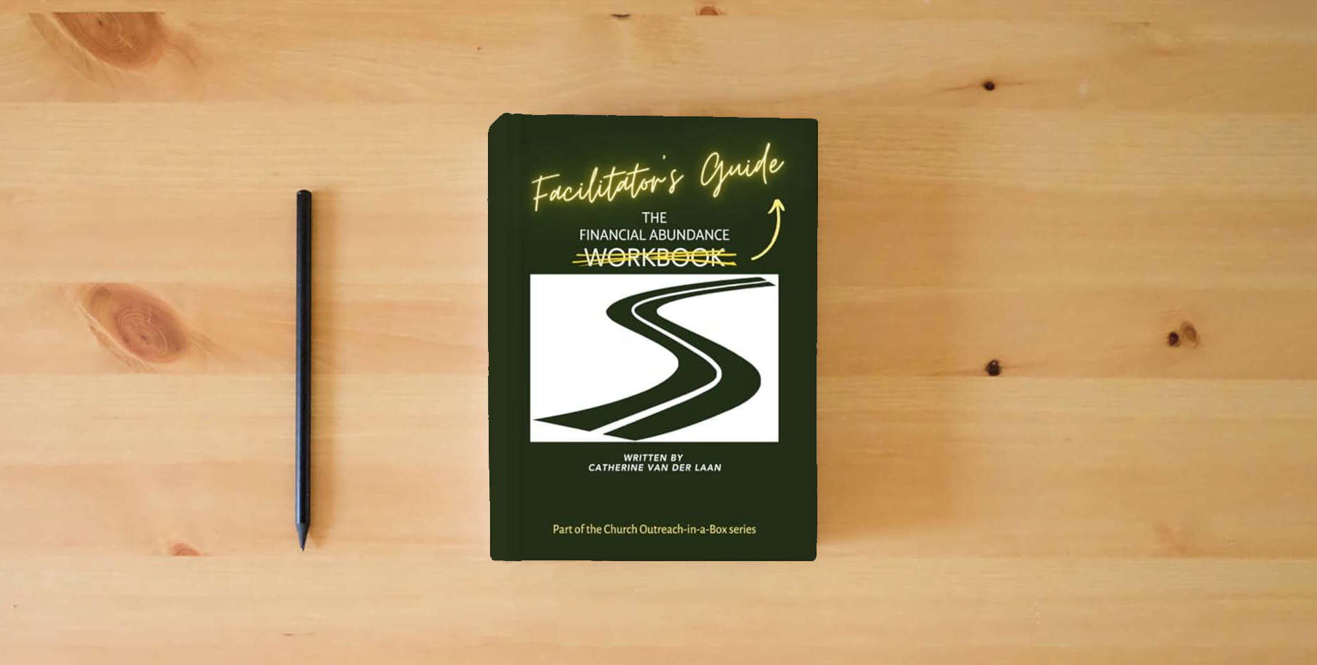 The book The Financial Abundance Facilitator's Guide: In the Church Outreach-in-a-Box series is on the table