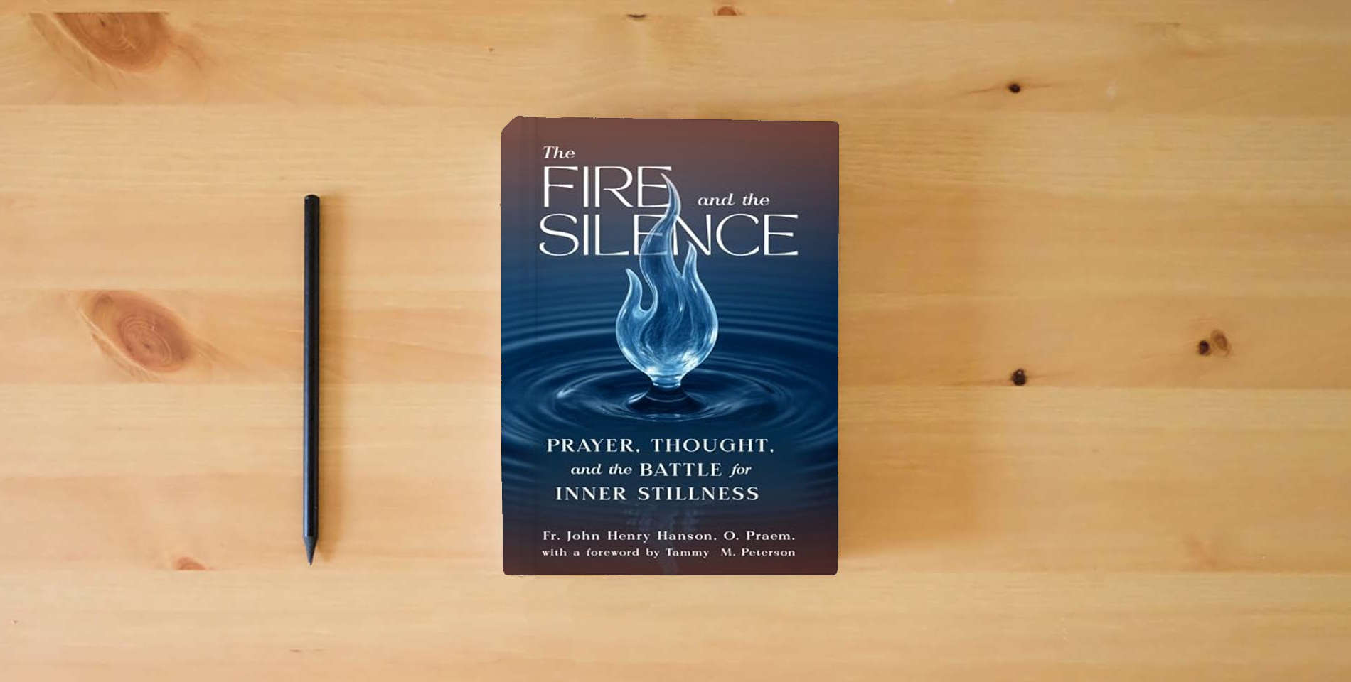 The book The Fire and the Silence: Prayer, Thought, and the Battle for Inner Stillness is on the table