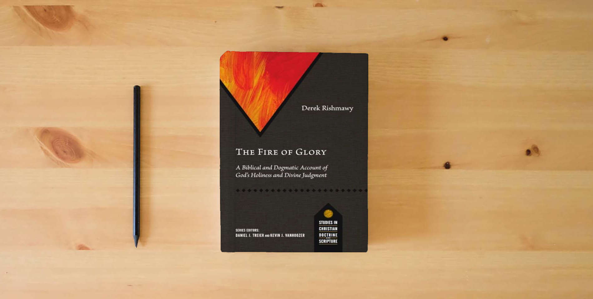 The book The Fire of Glory: A Biblical and Dogmatic Account of God's Holiness and Divine Judgment (Studies in Christian Doctrine and Scripture) is on the table