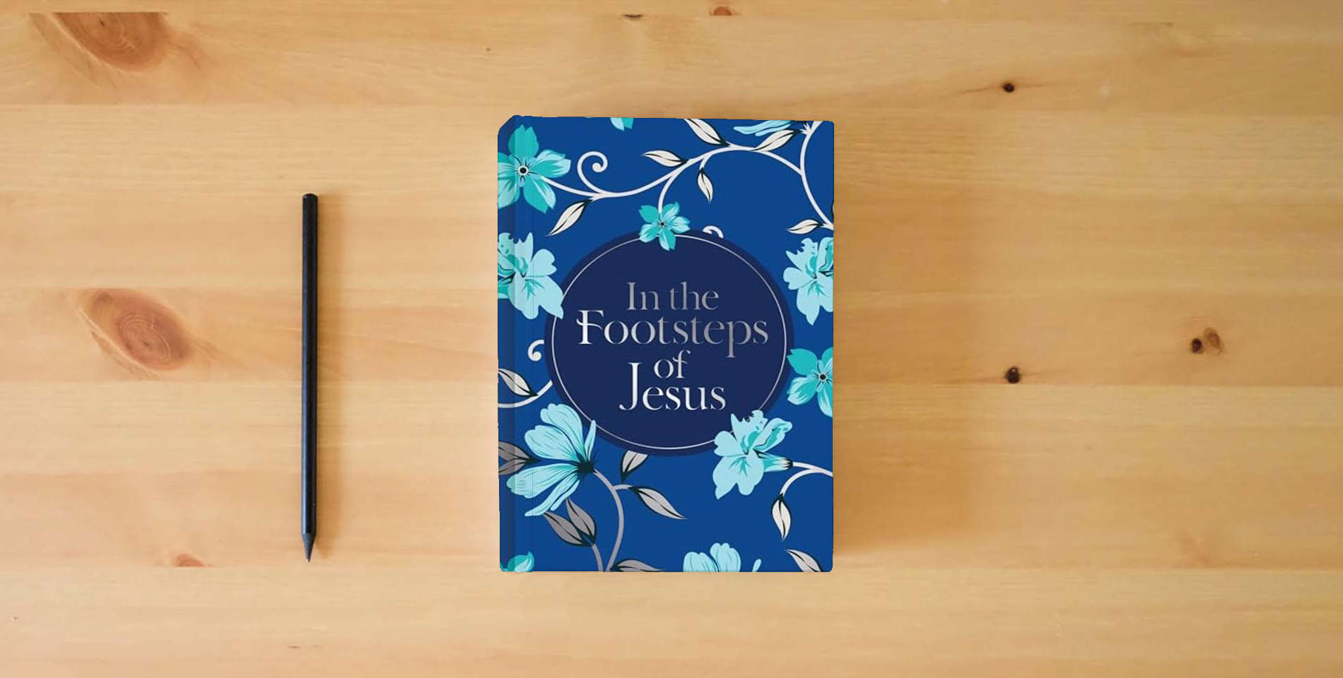 The book In the Footsteps of Jesus (Prayer Book) is on the table