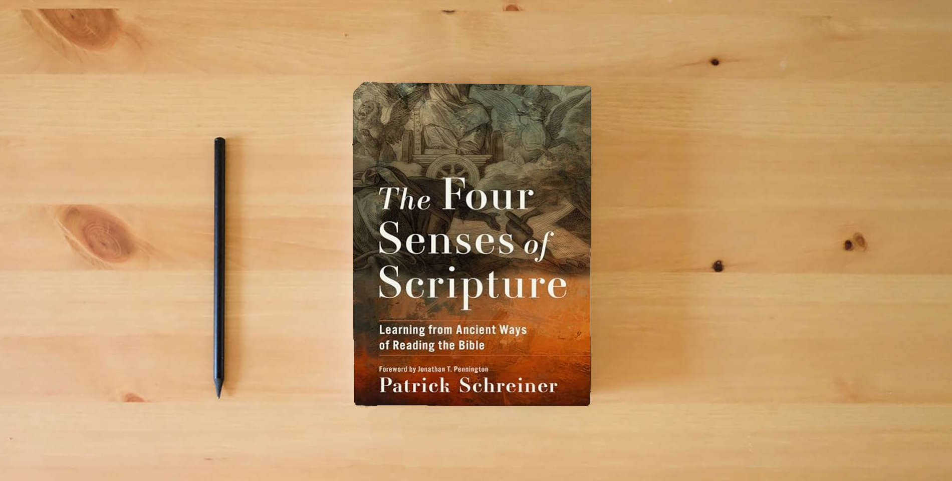 The book The Four Senses of Scripture: Learning from Ancient Ways of Reading the Bible is on the table