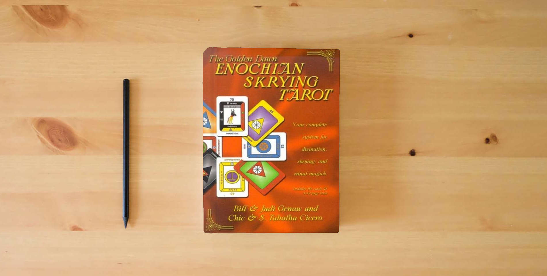 The book The Golden Dawn Enochian Skrying Tarot: Your Complete System for Divination, Skrying and Ritual Magick is on the table