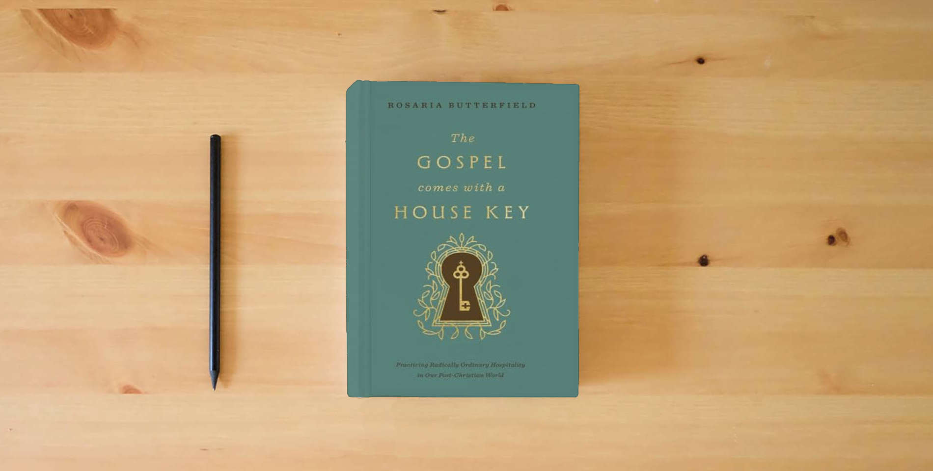 The book The Gospel Comes with a House Key: Practicing Radically Ordinary Hospitality in Our Post-Christian World (with Study Questions) is on the table