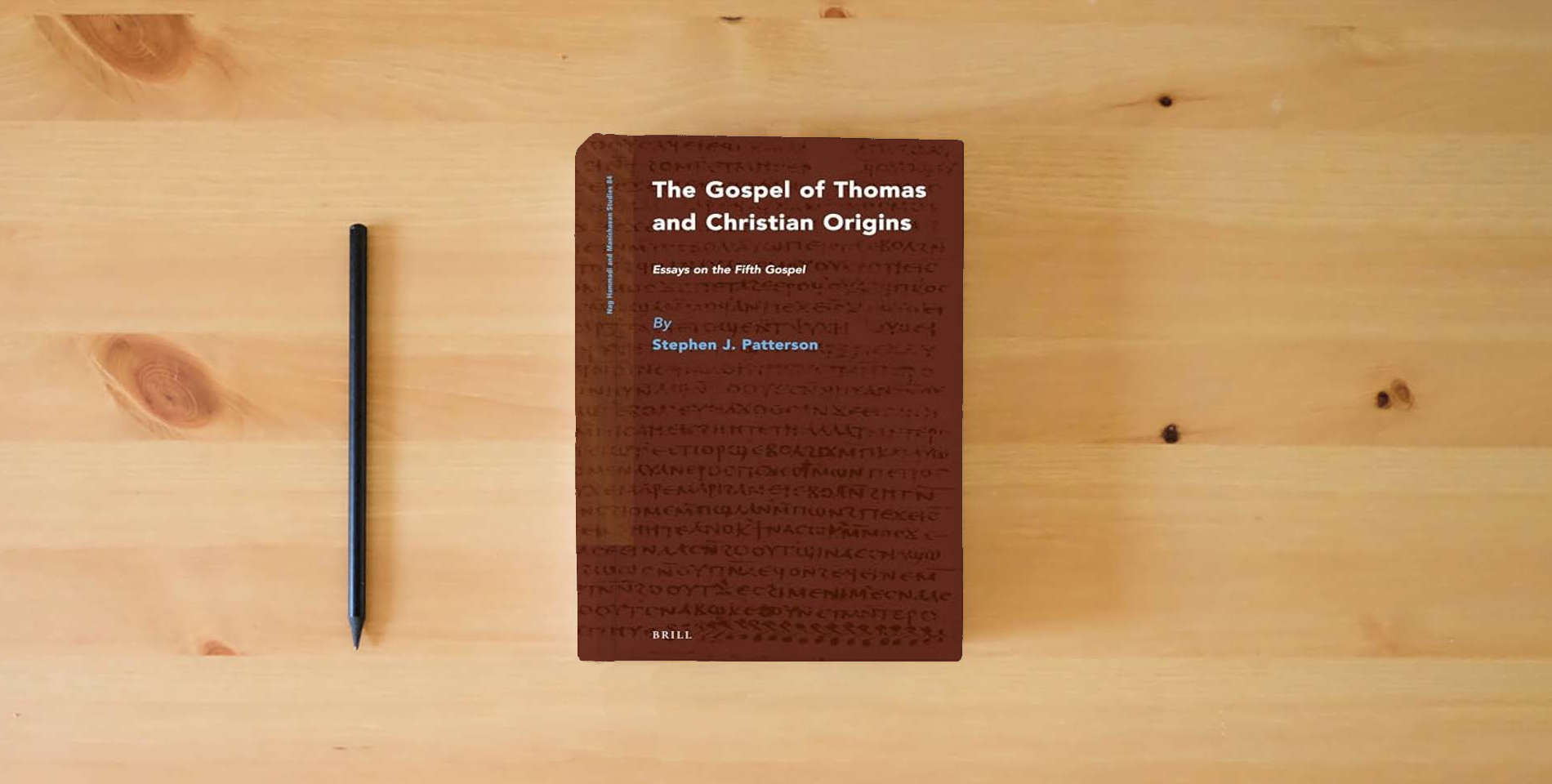 The book The Gospel of Thomas and Christian Origins: Essays on the Fifth Gospel (Nag Hammadi and Manichaean Studies, 84) is on the table