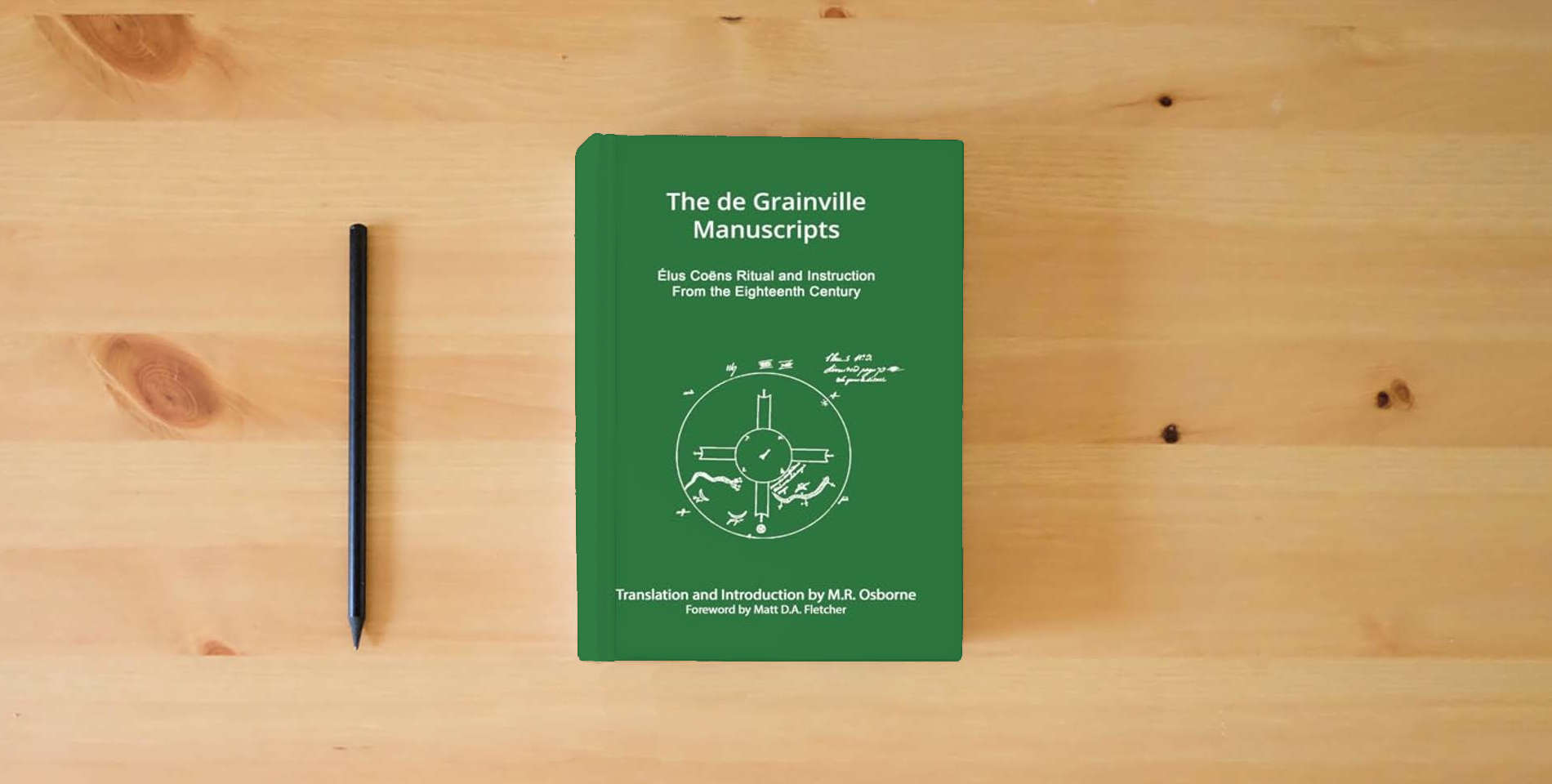 The book The de Grainville Manuscripts: Élus Coëns Ritual and Instruction from the Eighteenth Century (The Élus Coëns Library) is on the table