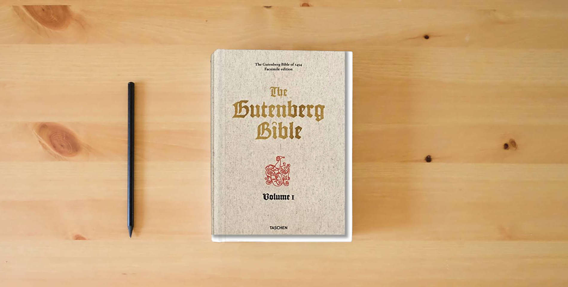 The book The Gutenberg Bible of 1454 is on the table