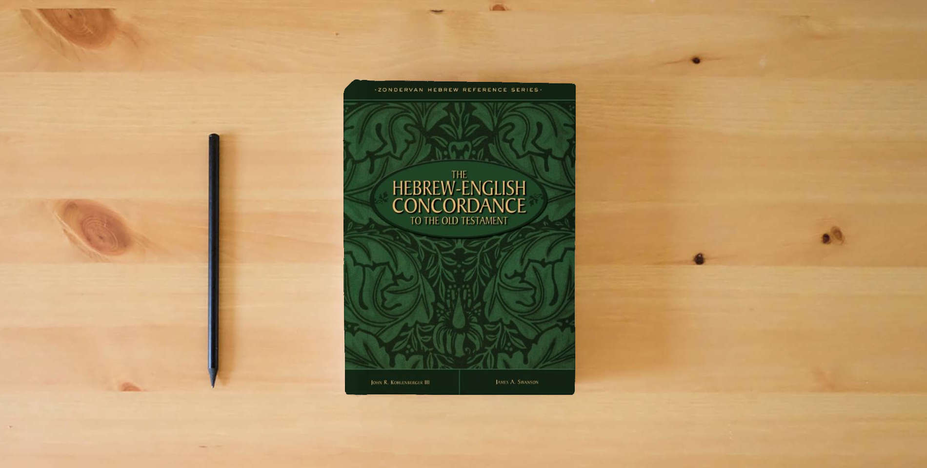 The book The Hebrew-English Concordance to the Old Testament is on the table