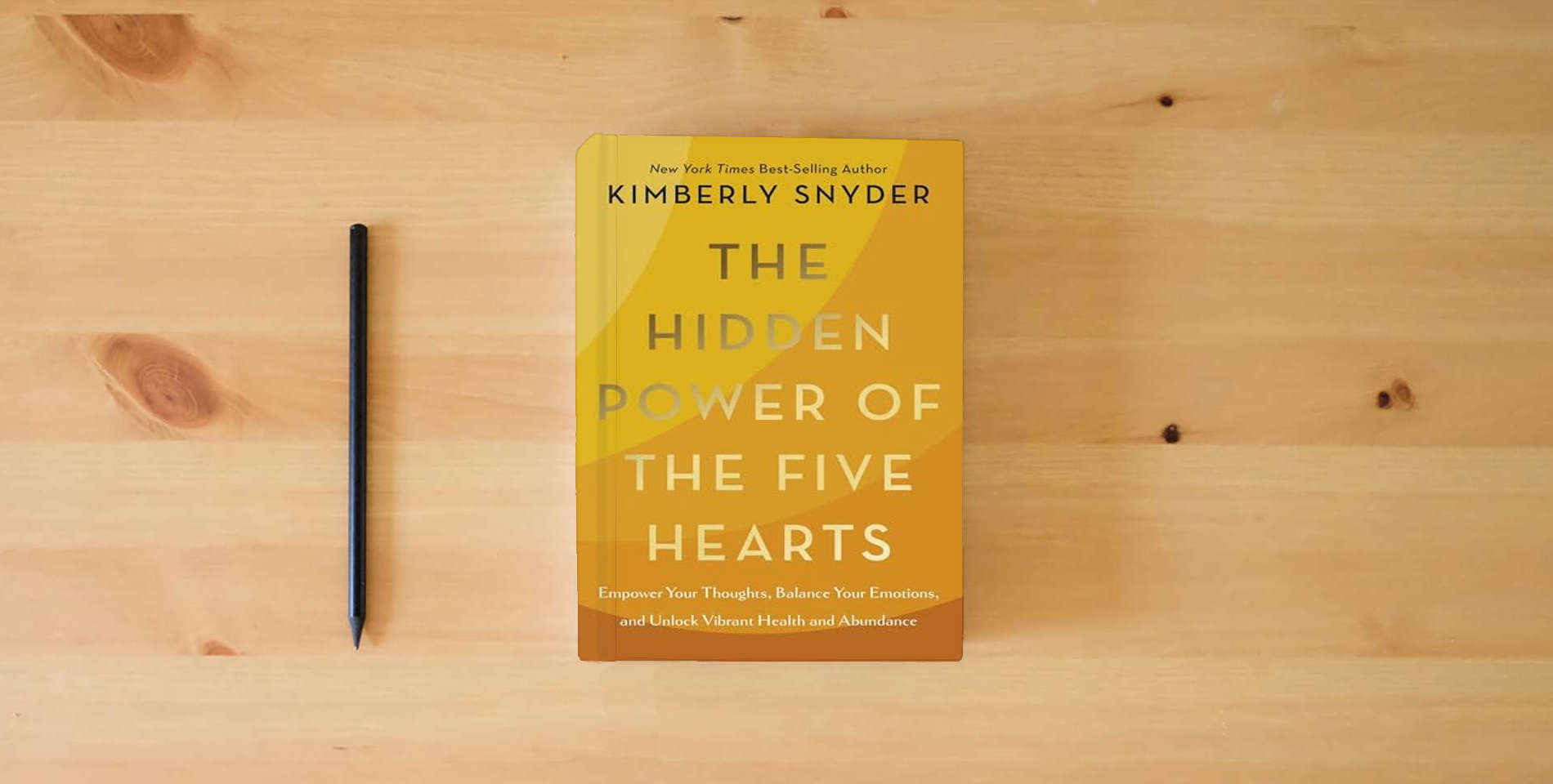 The book The Hidden Power of the Five Hearts: Empower Your Thoughts, Balance Your Emotions, and Unlock Vibrant Health and Abundance is on the table