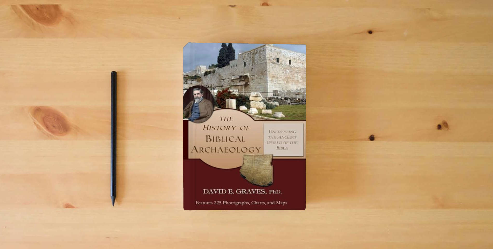 The book The History of Biblical Archaeology: Uncovering the Ancient World of the Bible is on the table