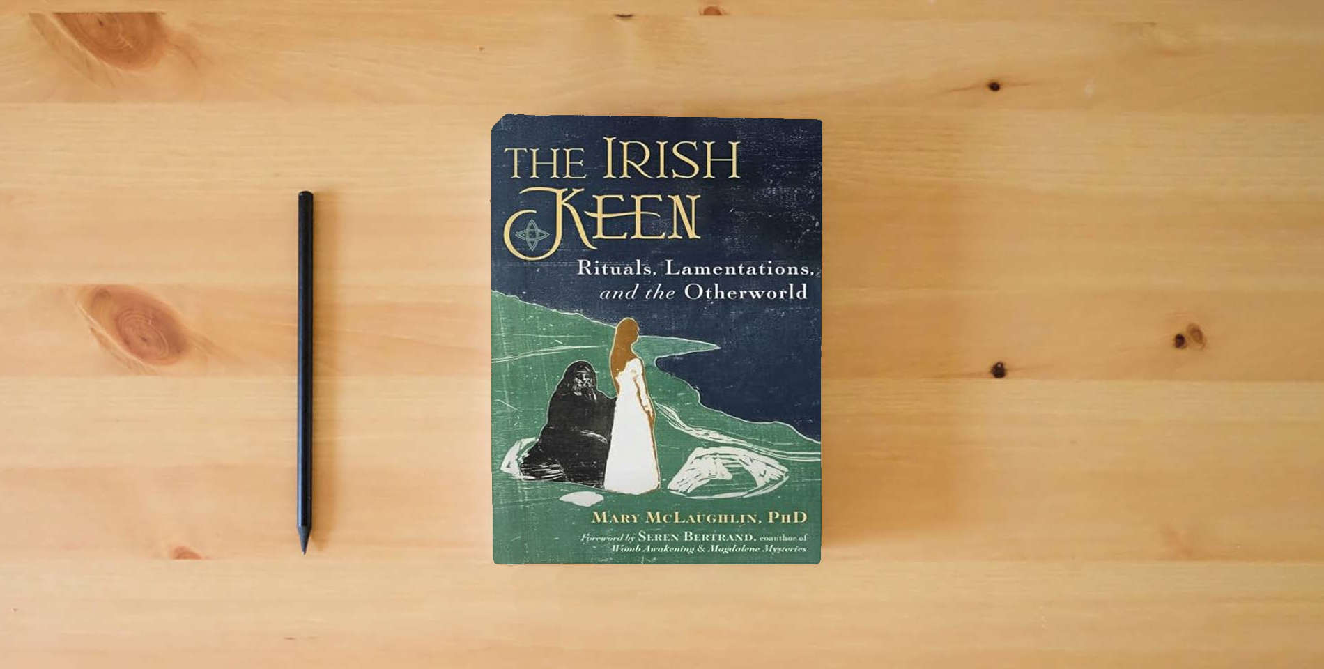 The book The Irish Keen: Grief Rituals and the Otherworld is on the table