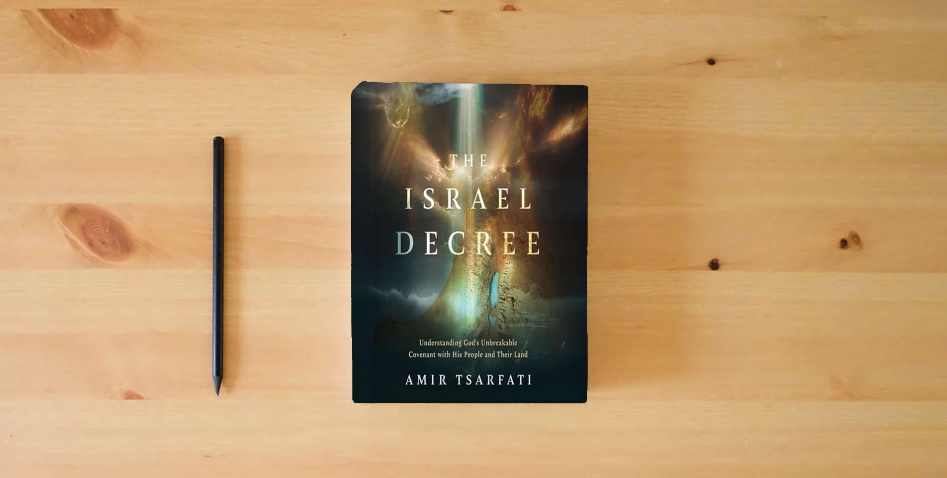 The book The Israel Decree: The Past, Present, and Future of the World's Most Controversial Strip of Land is on the table