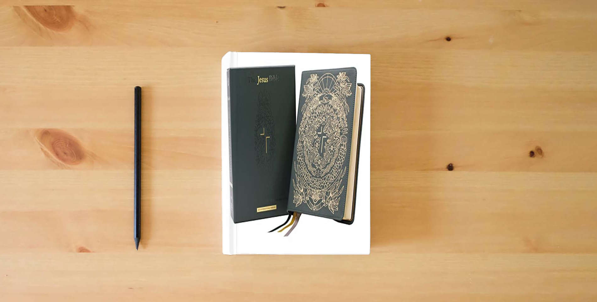 The book The Jesus Bible Artist Edition, NIV, Genuine Leather, Calfskin, Green, Limited Edition, Comfort Print is on the table