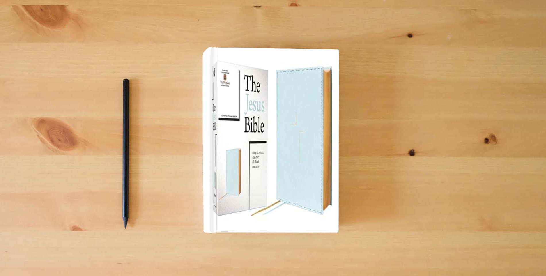 The book The Jesus Bible, NIV Edition, Leathersoft over Board, Blue, Comfort Print is on the table