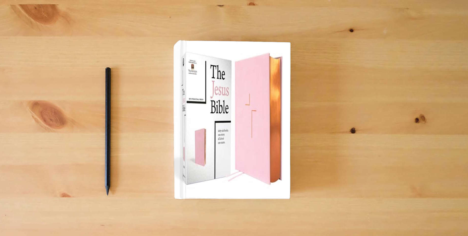 The book The Jesus Bible, NIV Edition, Leathersoft over Board, Pink, Comfort Print is on the table