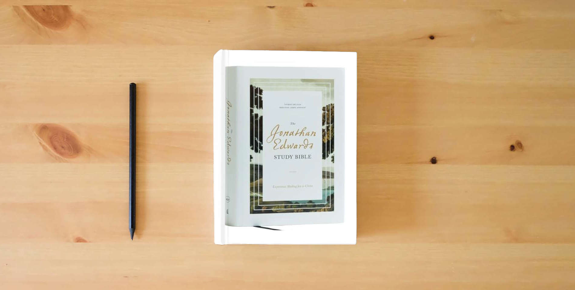 The book The Jonathan Edwards Study Bible: Experience Abiding Joy in Christ (NKJV, Hardcover, Red Letter, Comfort Print) is on the table