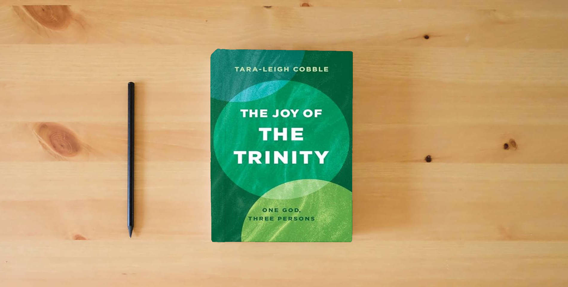 The book The Joy of the Trinity: One God, Three Persons is on the table