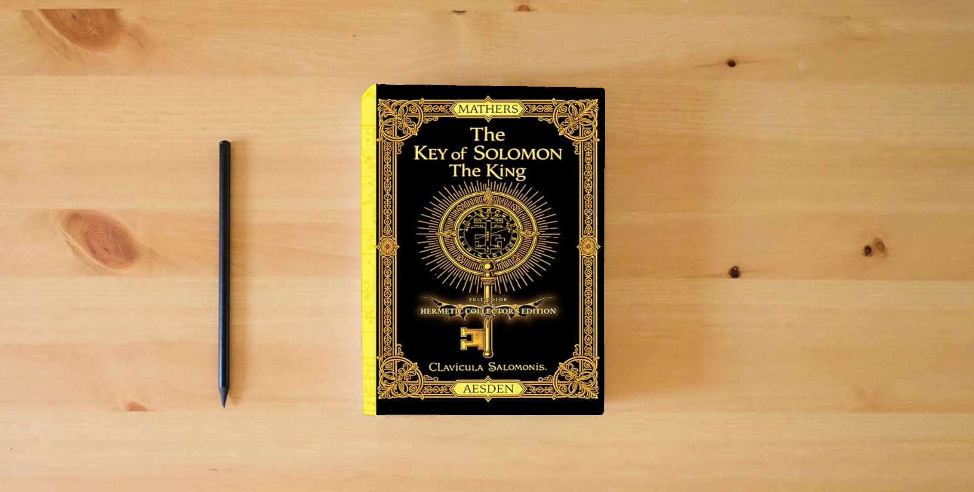 The book The Key of Solomon the King (Clavicula Salomonis) (Illustrated) (Annotated): Full-Color Hermetic Collector’s Edition is on the table