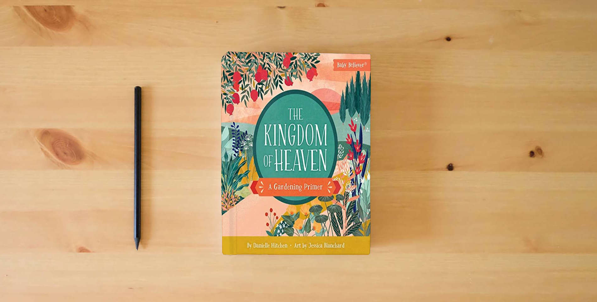 The book The Kingdom of Heaven: Christian Board Book Exploring God's Kingdom Through Gardens and Scripture (Baby Believer) is on the table