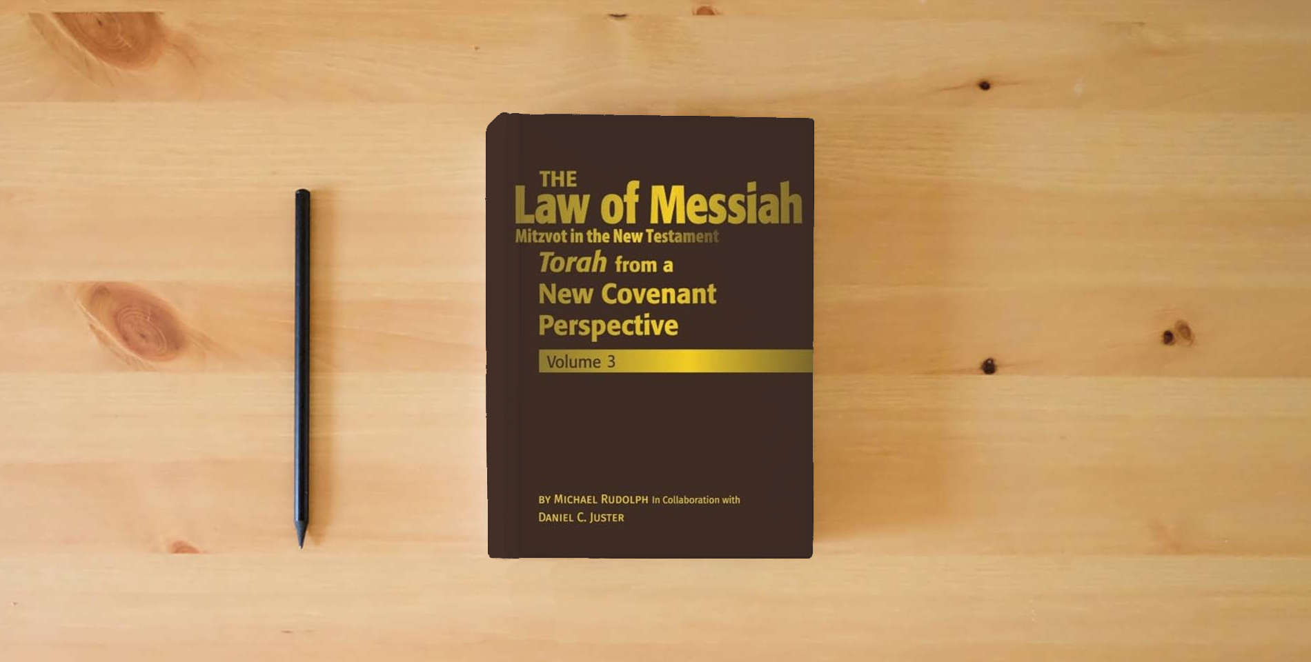 The book The Law of Messiah Volume 3: Torah from a New Covenant Perspective (The Law of Messiah: Torah from a New Covenant Perspective) is on the table