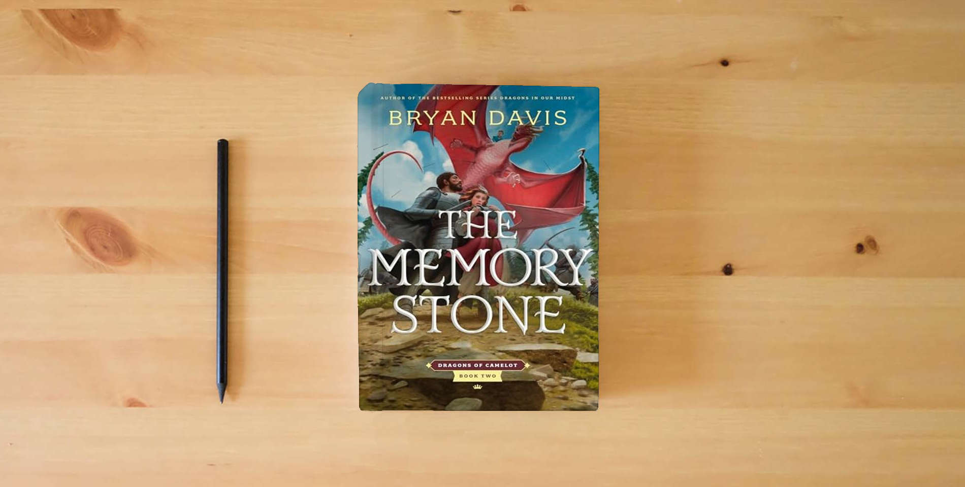 The book The Memory Stone (Dragons of Camelot) is on the table