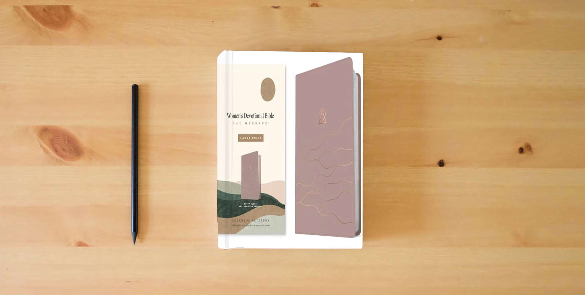 The book The Message Women’s Devotional Bible Large Print (Leather-Look, Dusty Blush) is on the table