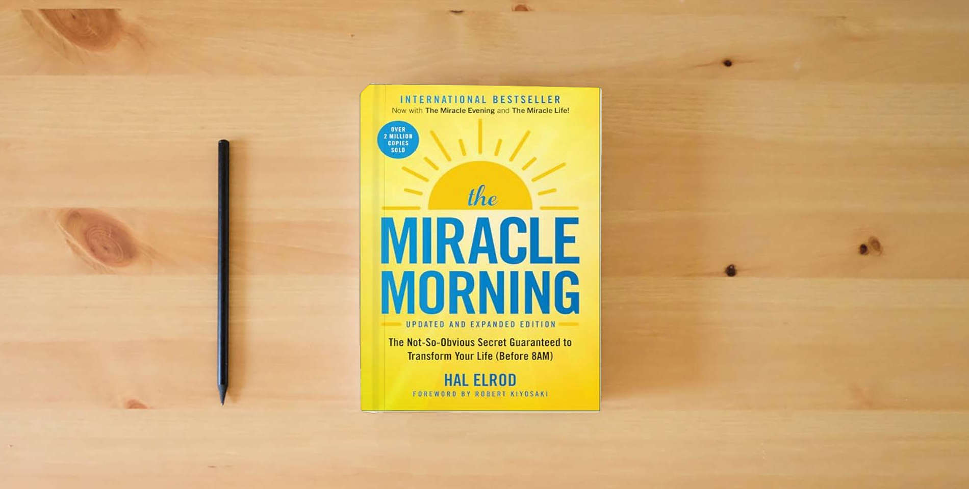The book The Miracle Morning (Updated and Expanded Edition): The Not-So-Obvious Secret Guaranteed to Transform Your Life (Before 8AM) (Miracle Morning Book Series) is on the table