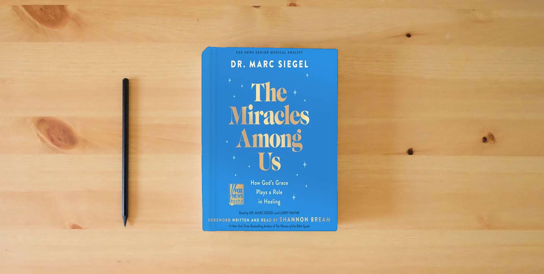 The book The Miracles Among Us: How God's Grace Plays a Role in Healing is on the table