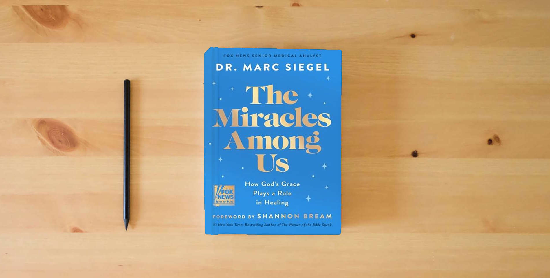 The book The Miracles Among Us: How God's Grace Plays a Role in Healing is on the table