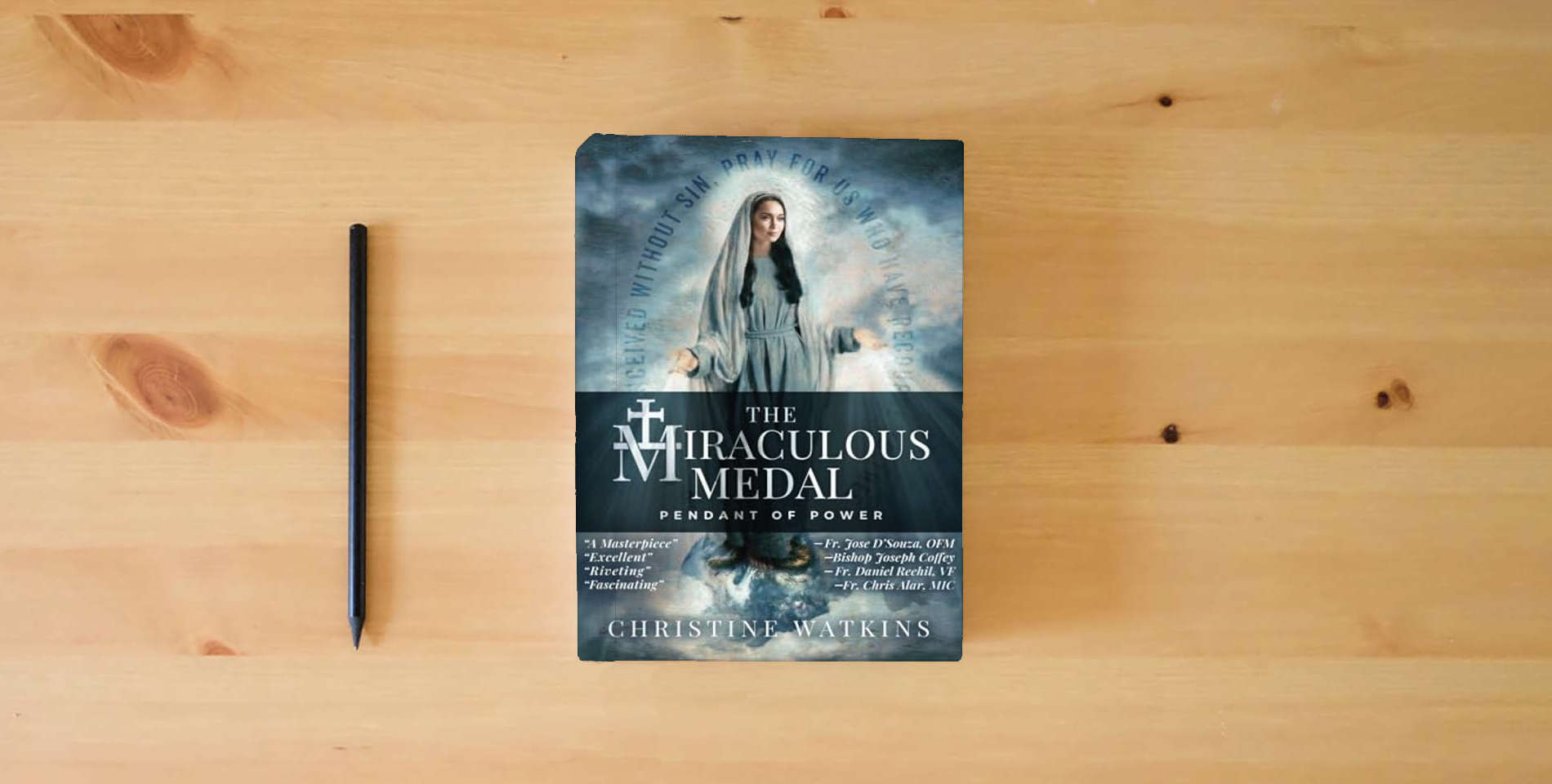 The book The Miraculous Medal: Pendant of Power is on the table