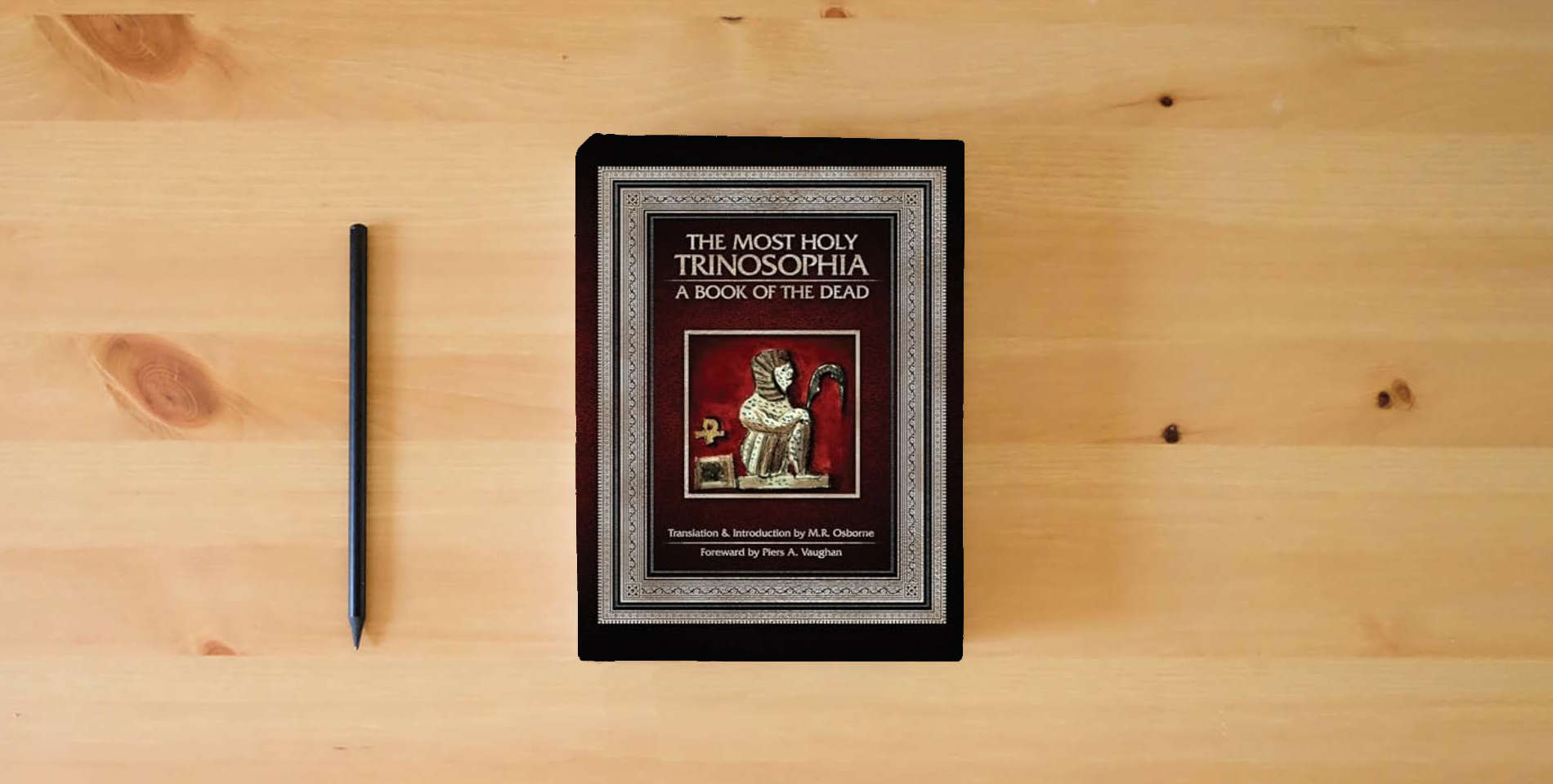 The book The Most Holy Trinosophia: A Book of the Dead is on the table