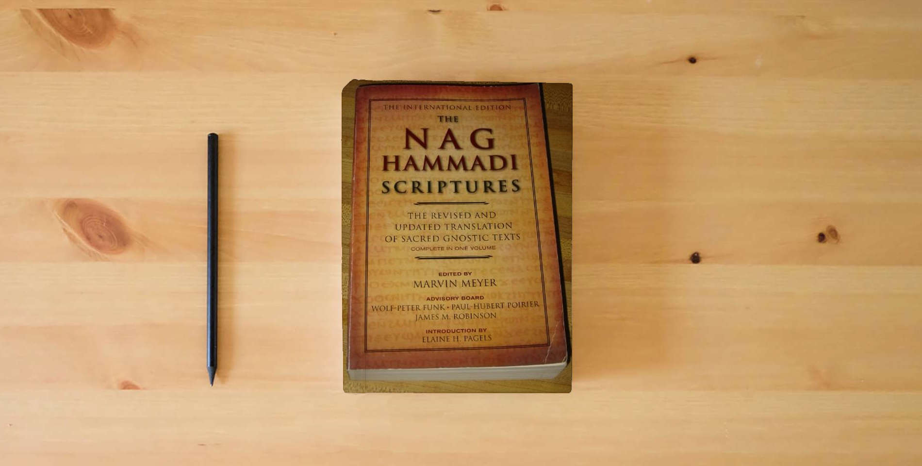 The book The Nag Hammadi Scriptures: The International Edition is on the table