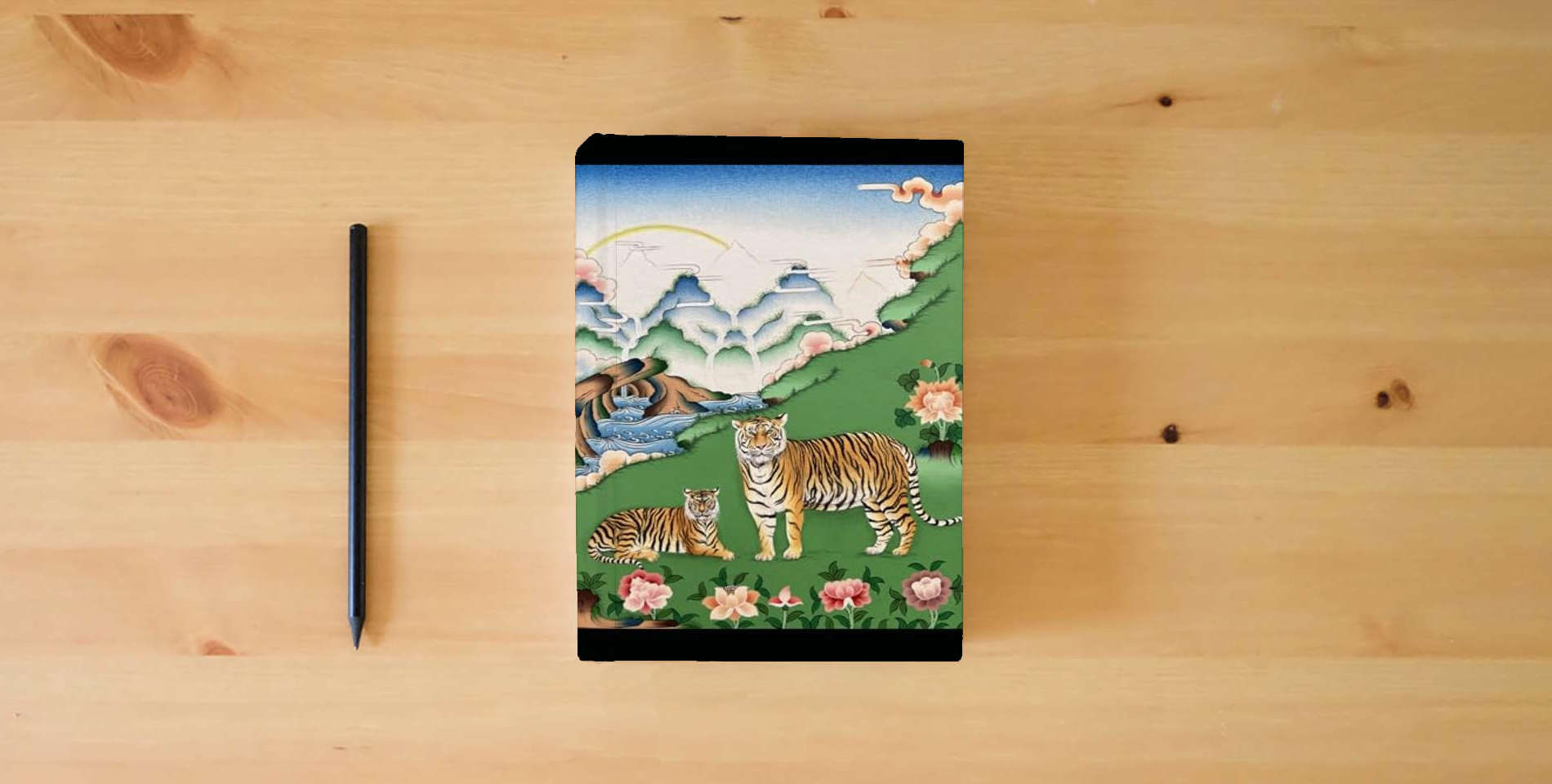 The book The Neck Breaker: Ten Tantras of the Universal Ti is on the table