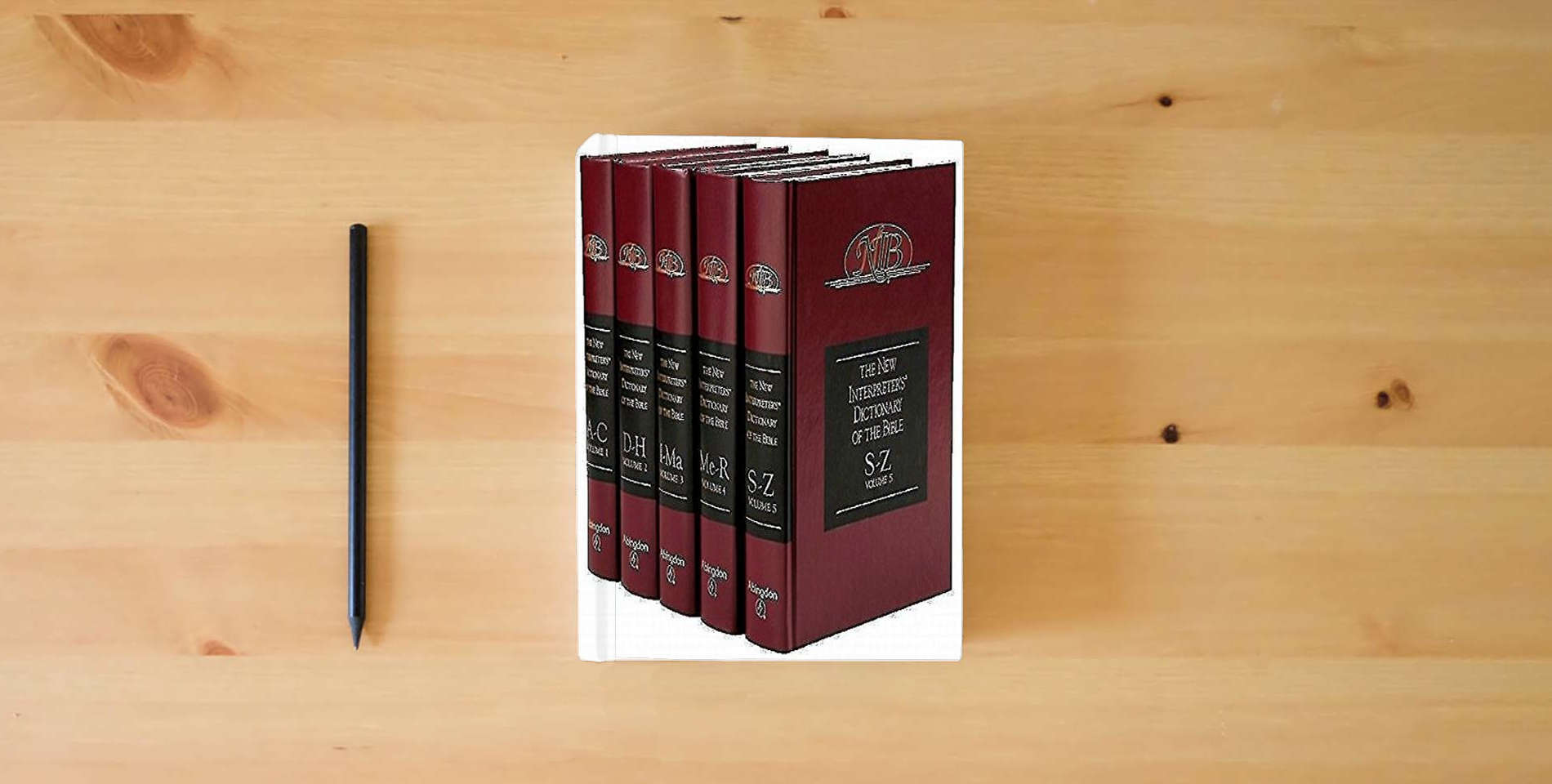 The book The New Interpreter's Dictionary of the Bible (5 Volumes) is on the table