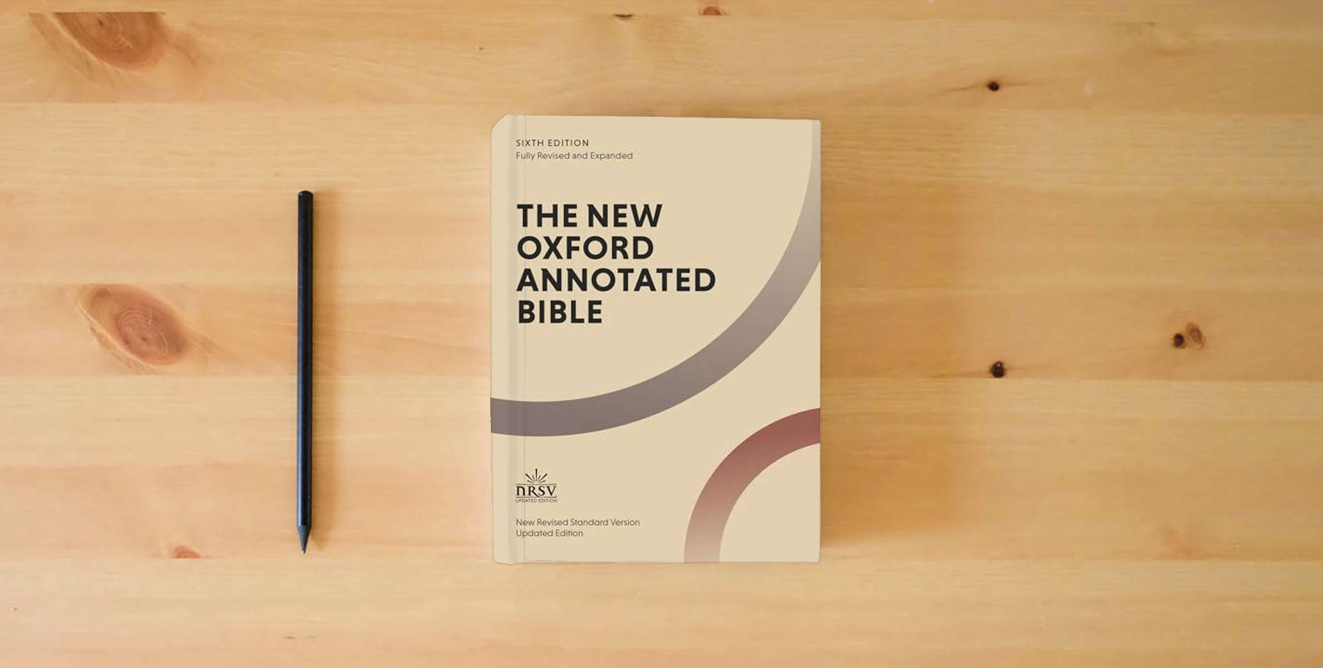 The book The New Oxford Annotated Bible: New Revised Standard Version is on the table
