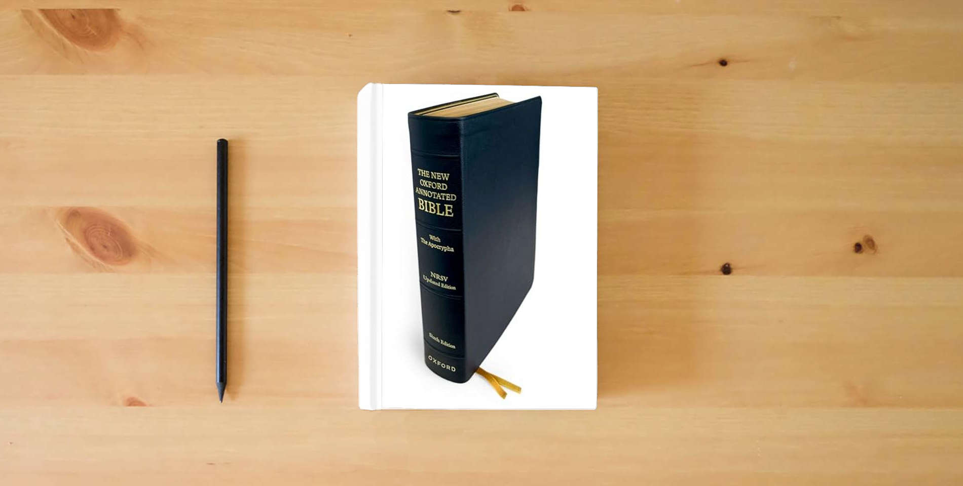 The book The New Oxford Annotated Bible: New Revised Standard Version with the Apocrypha is on the table