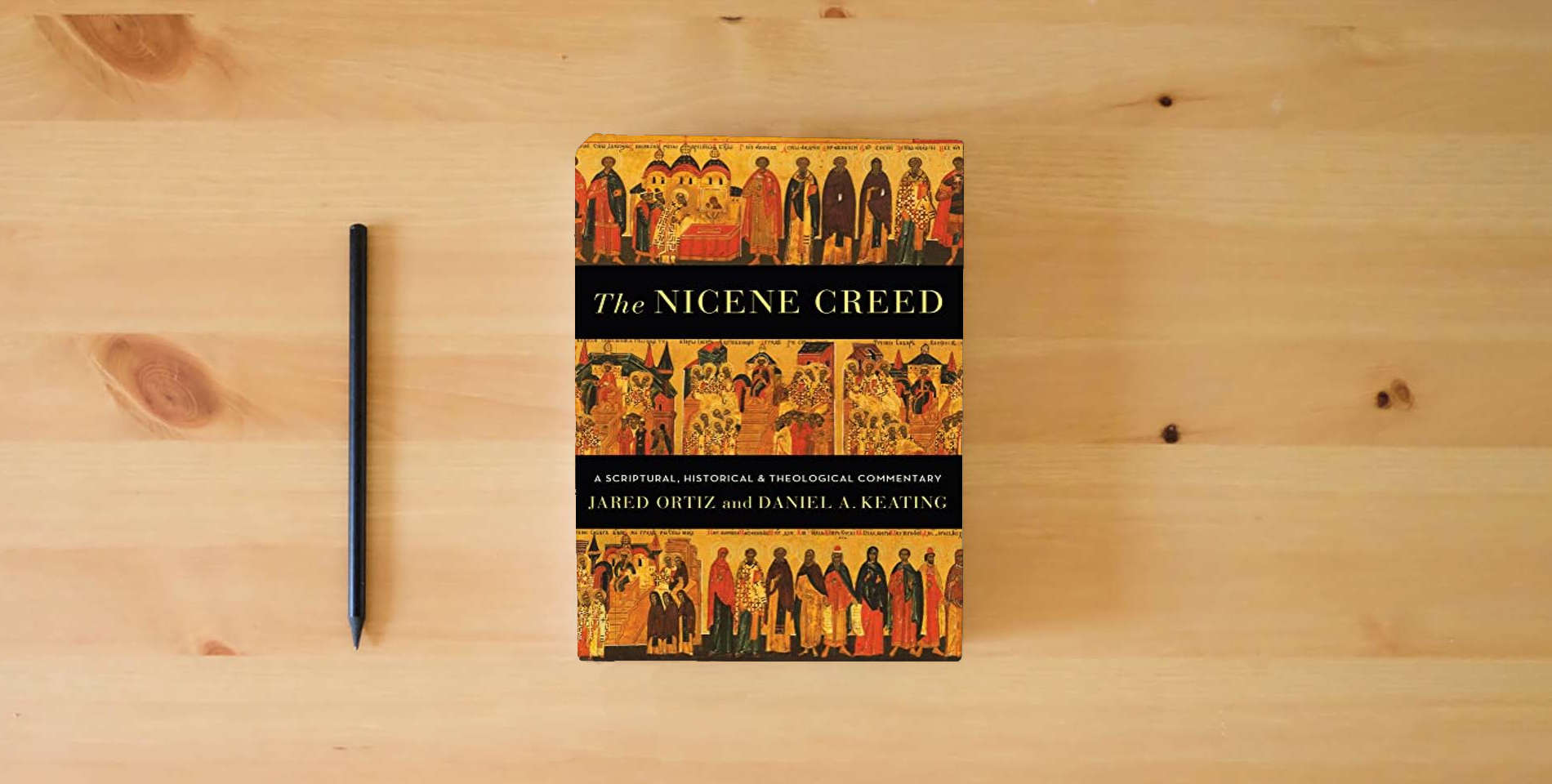 The book The Nicene Creed: A Scriptural, Historical, and Theological Commentary is on the table
