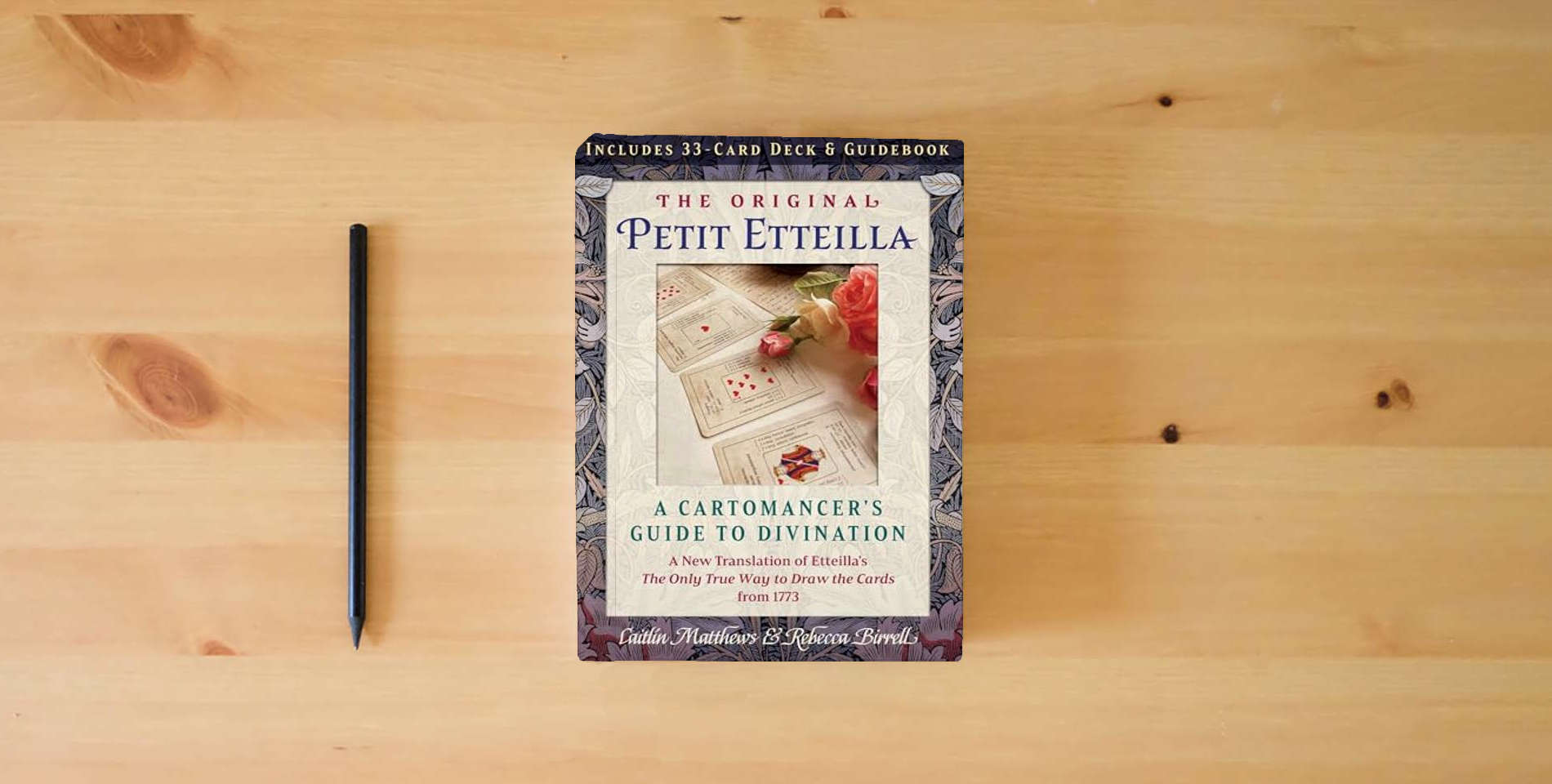 The book The Original Petit Etteilla: A Cartomancer's Guide to Divination is on the table