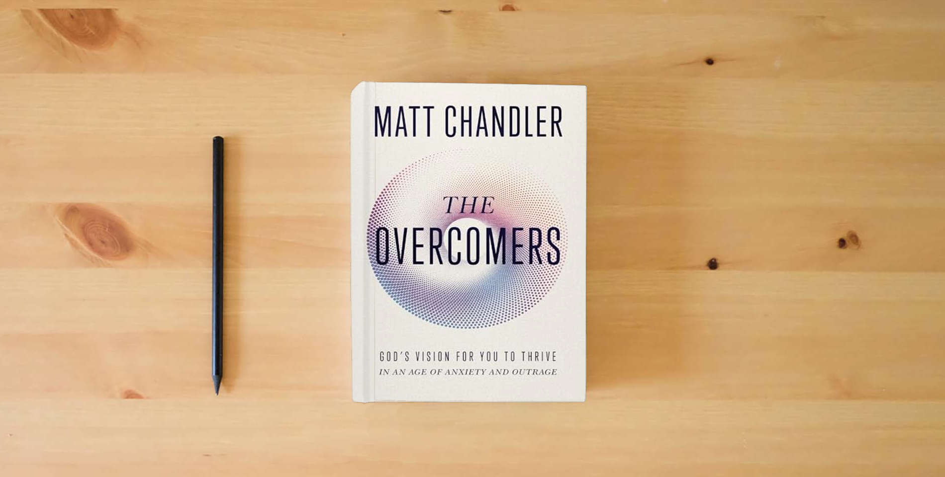 The book The Overcomers: God's Vision for You to Thrive in an Age of Anxiety and Outrage is on the table