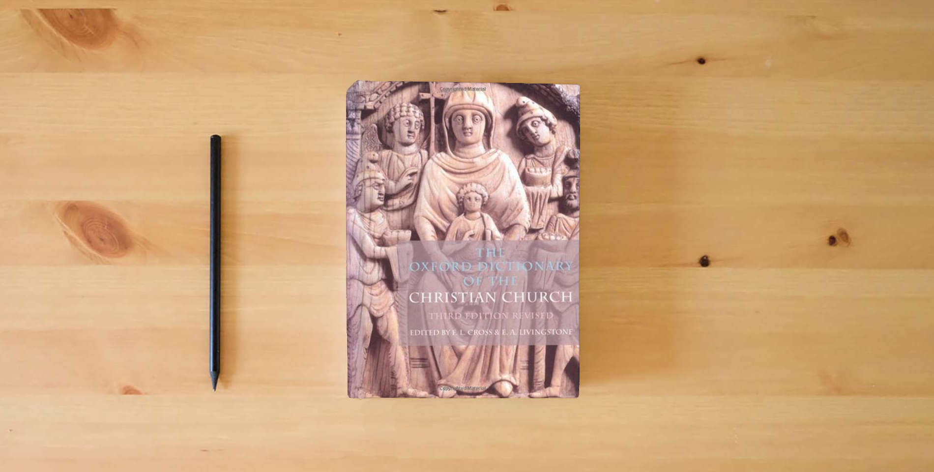 The book The Oxford Dictionary of the Christian Church is on the table