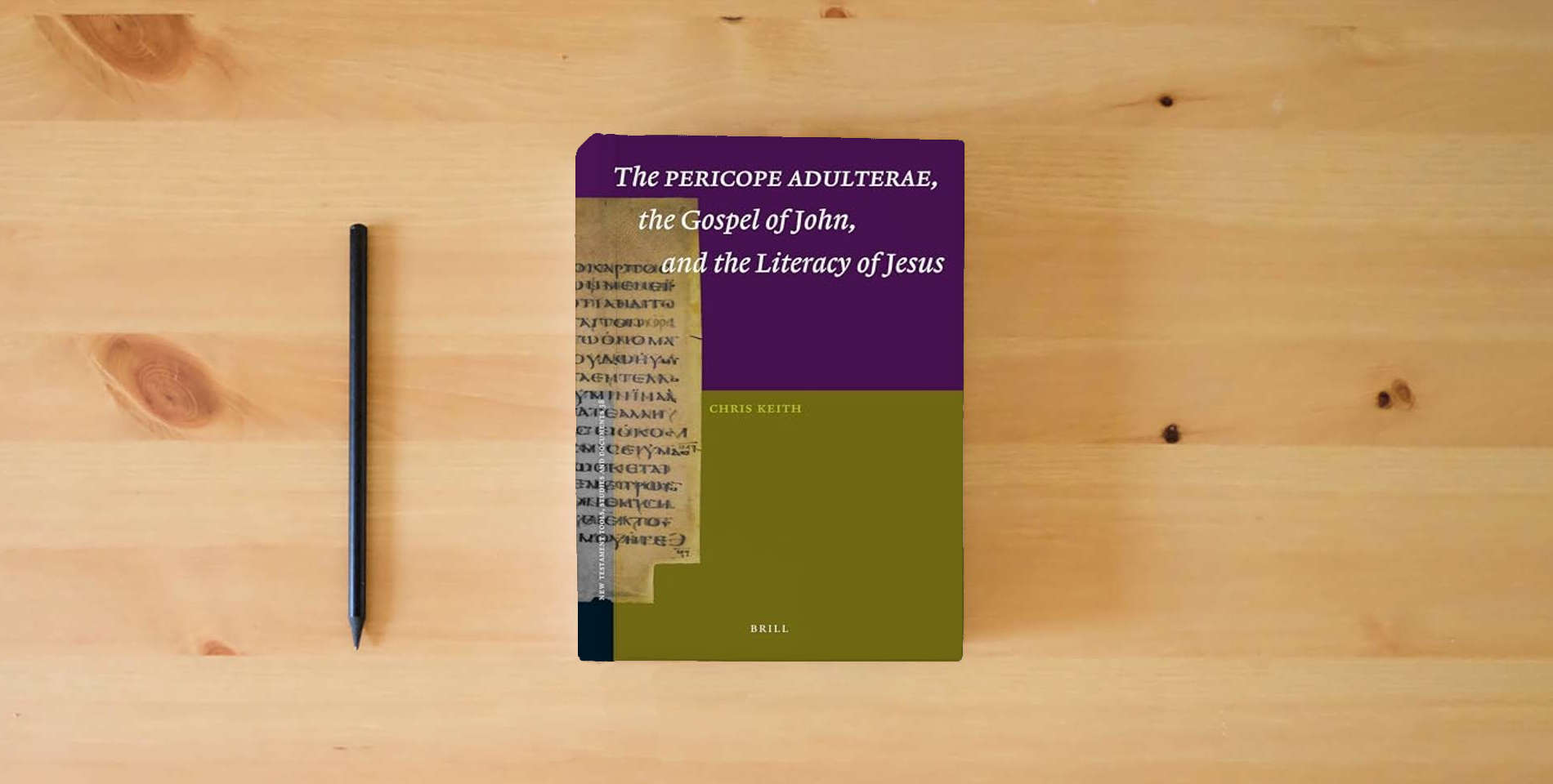 The book The Pericope Adulterae, the Gospel of John, and the Literacy of Jesus (New Testament Tools, Studies and Documents, 38) is on the table