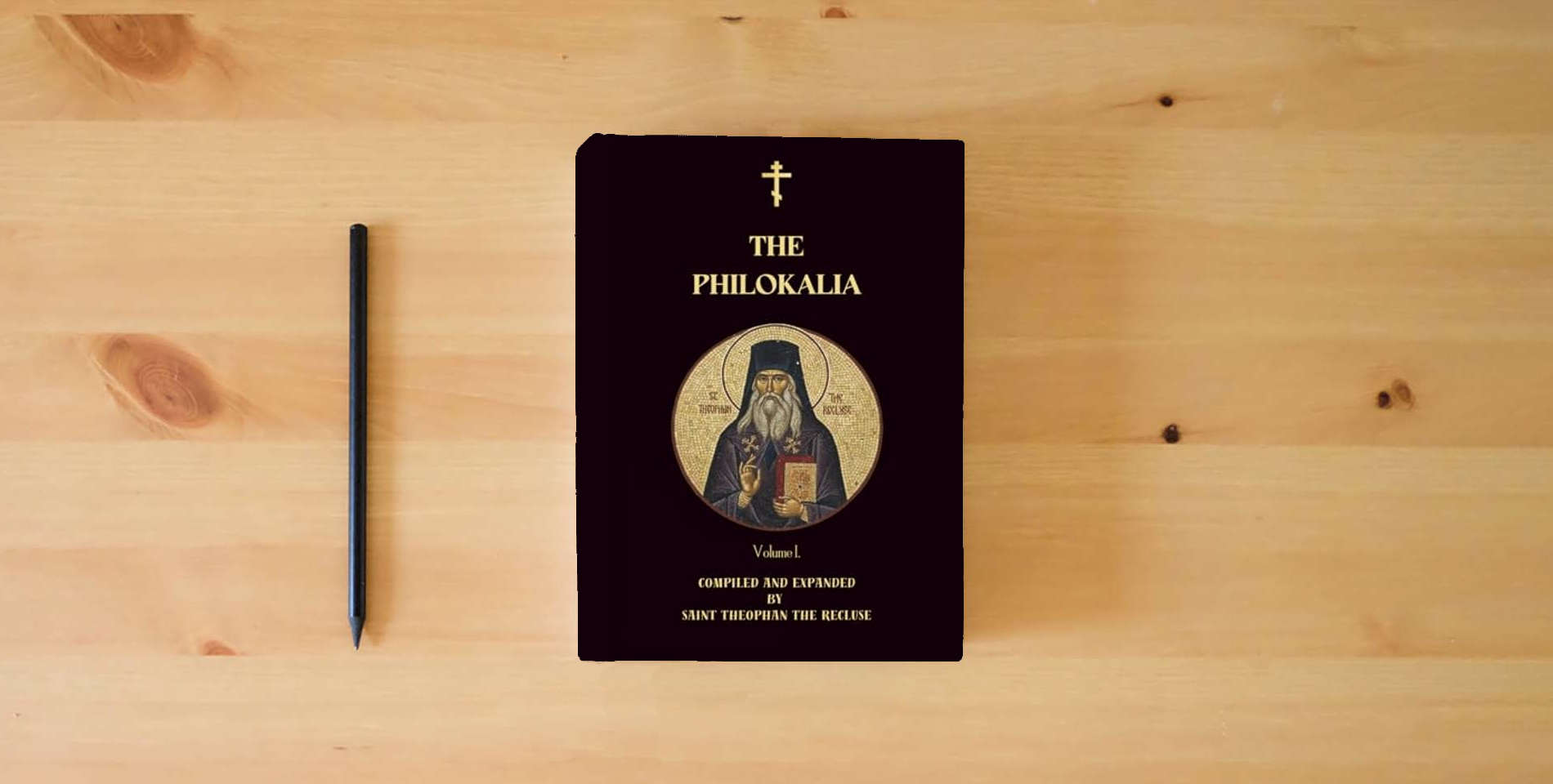 The book The Philokalia Volume 1: Saint Anthony the Great, Saint Macarius the Great, Venerable Abba Isaiah, Saint Mark the Ascetic, Abba Evagrius (Orthodox Christian Publications) is on the table