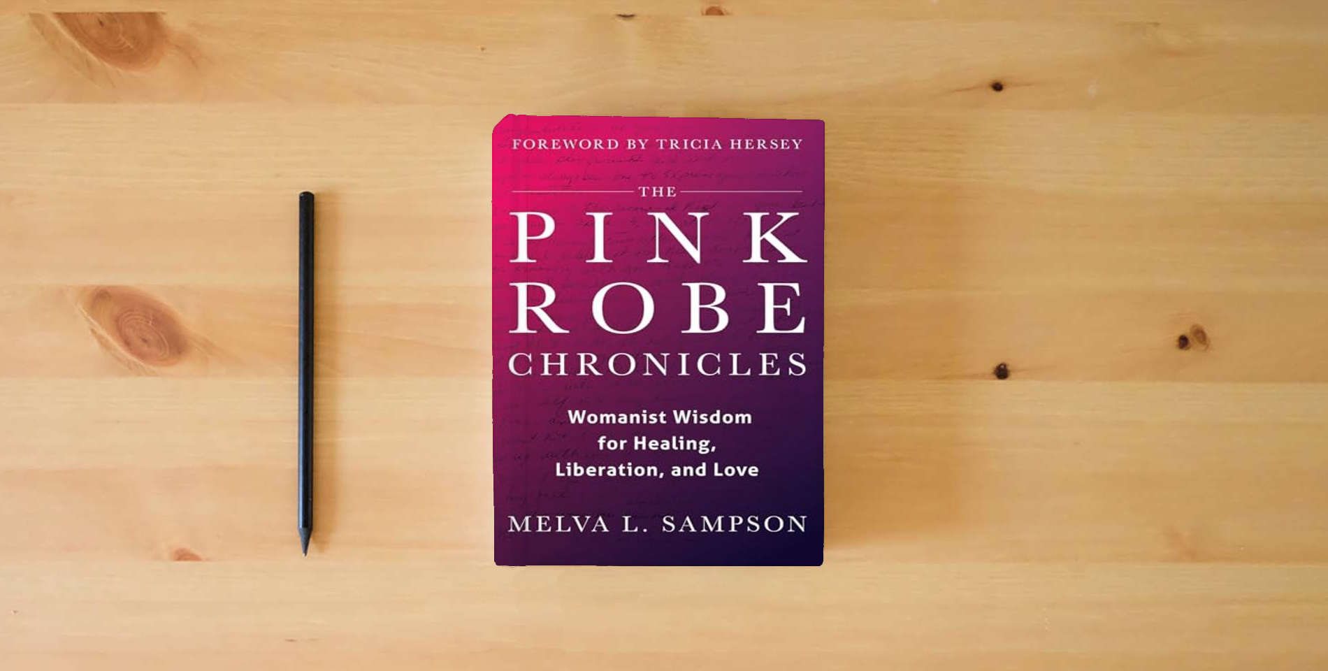 The book The Pink Robe Chronicles: Womanist Wisdom for Healing, Liberation, and Love is on the table