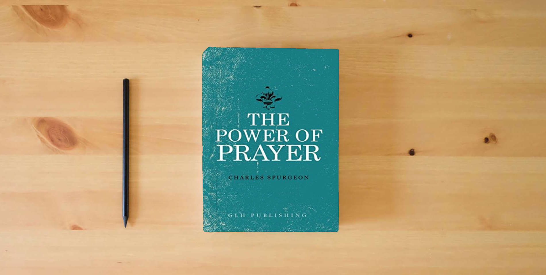 The book The Power of Prayer is on the table