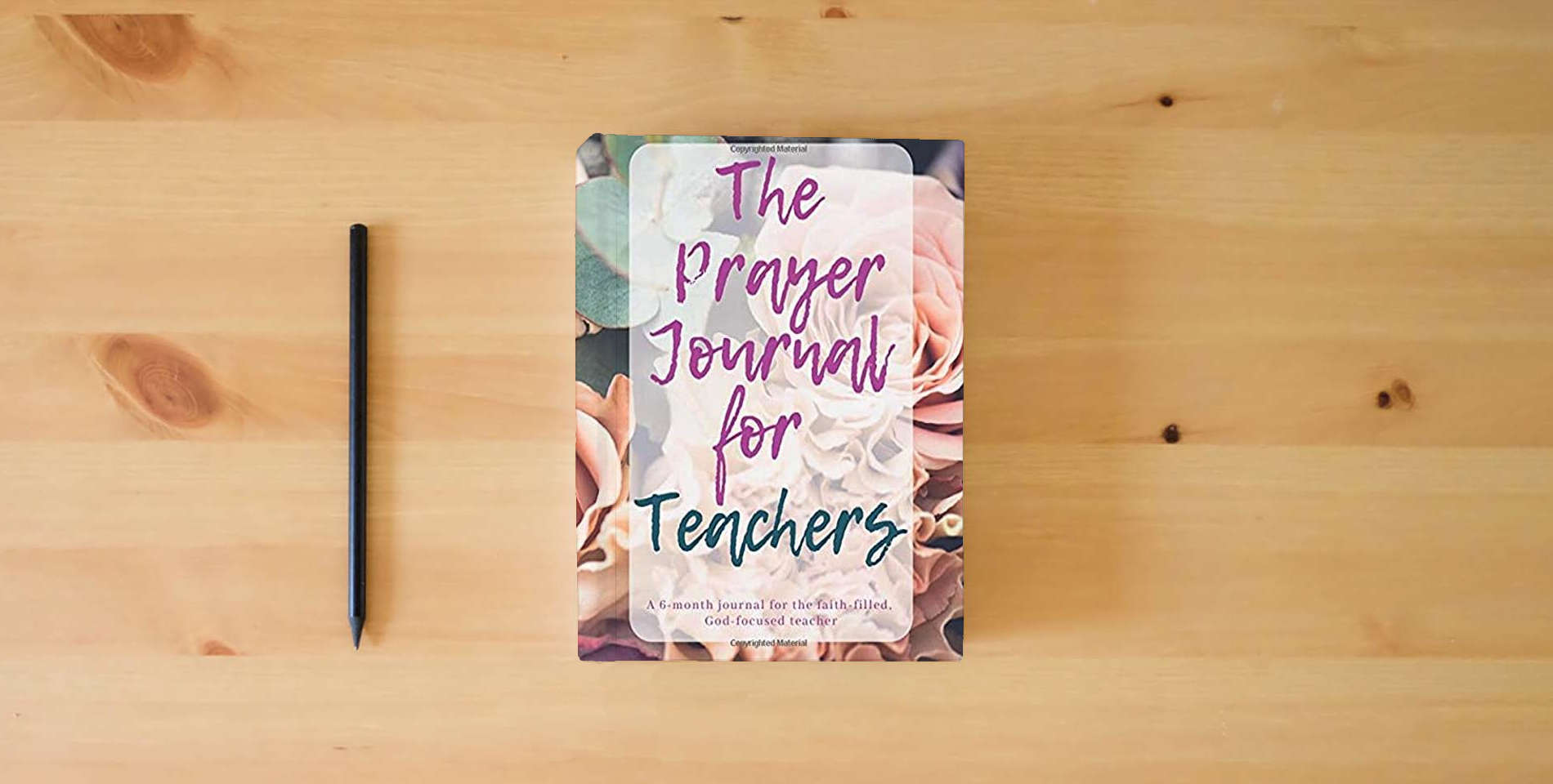 The book The Prayer Journal for Teachers is on the table